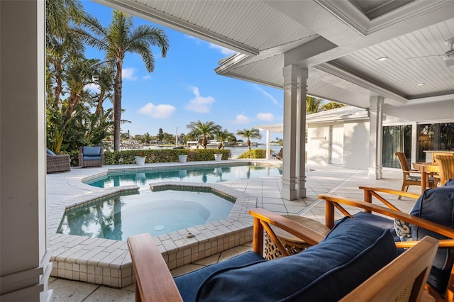 outdoor pool with an in ground hot tub and a patio