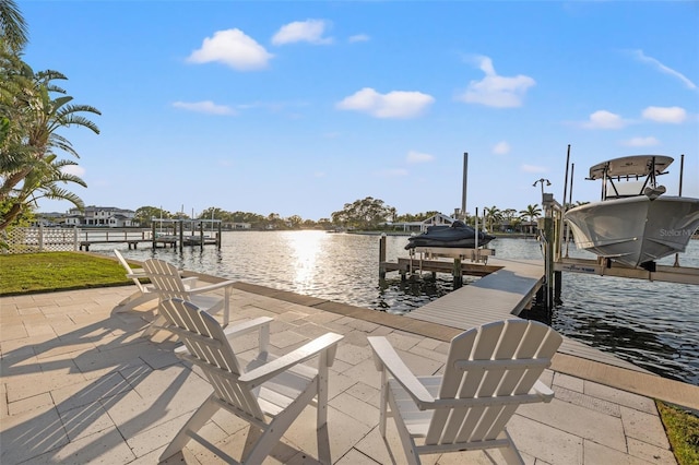 dock area with boat lift and a water view