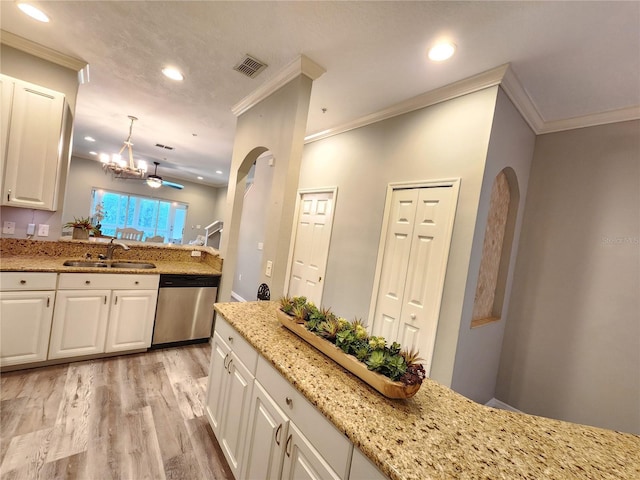 kitchen with dishwasher, visible vents, ornamental molding, and a sink