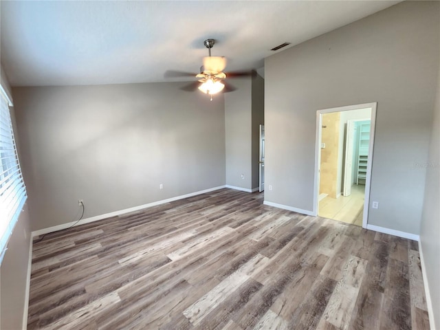 empty room with wood finished floors, visible vents, baseboards, and ceiling fan