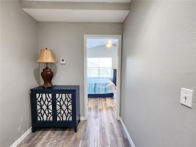 hall featuring wood finished floors and baseboards
