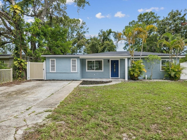 232 Emerald Ln, Largo, FL 33771 - ranch-style house with stucco siding and covered porch