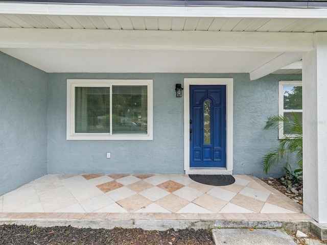 232 Emerald Ln, Largo, FL 33771 - doorway to property featuring stucco siding