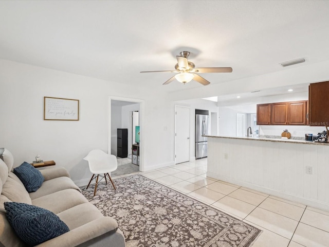 232 Emerald Ln, Largo, FL 33771 - living area featuring light tile patterned flooring and a ceiling fan