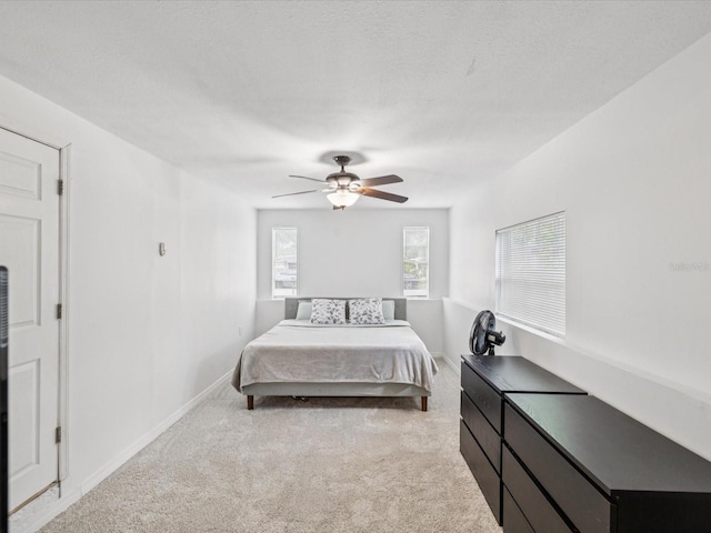 232 Emerald Ln, Largo, FL 33771 - bedroom with light carpet and a ceiling fan