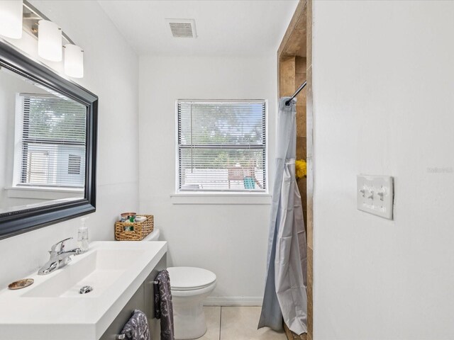 232 Emerald Ln, Largo, FL 33771 - bathroom featuring vanity, tile patterned floors, plenty of natural light, and a shower with shower curtain