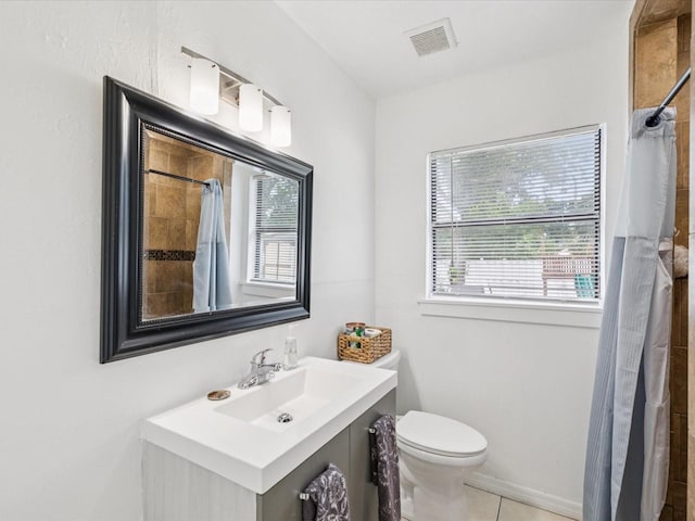 232 Emerald Ln, Largo, FL 33771 - bathroom featuring a tile shower, vanity, and tile patterned floors