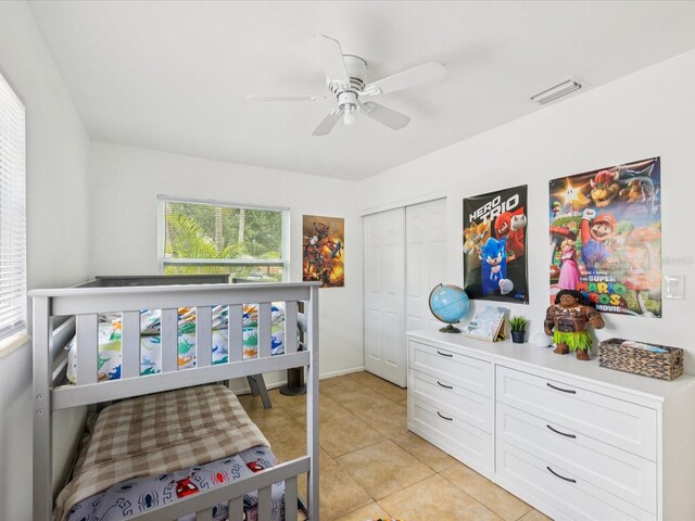 232 Emerald Ln, Largo, FL 33771 - bedroom featuring light tile patterned flooring, a closet, and ceiling fan