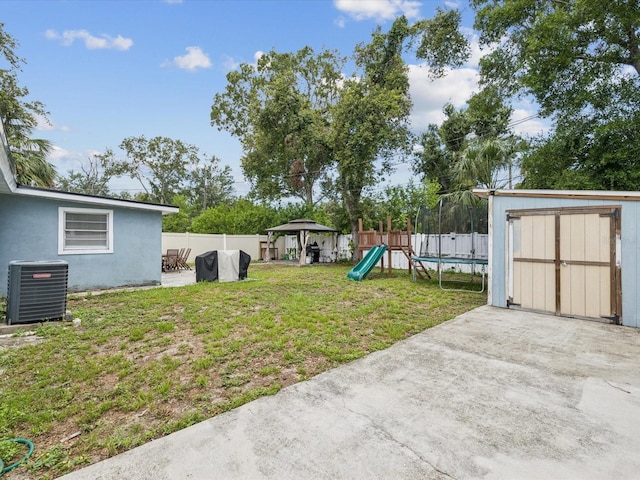 232 Emerald Ln, Largo, FL 33771 - fenced backyard featuring a trampoline, a shed, a gazebo, a playground, and a patio