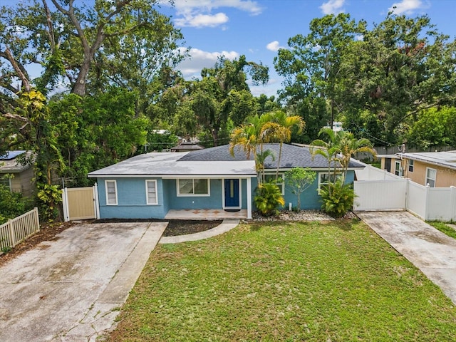 232 Emerald Ln, Largo, FL 33771 - ranch-style house with concrete driveway and a gate