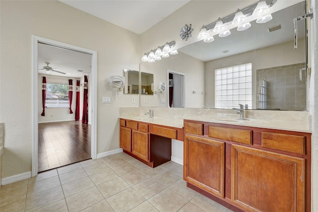 full bathroom with double vanity, tile patterned floors, a ceiling fan, and a sink