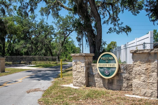 community sign featuring fence