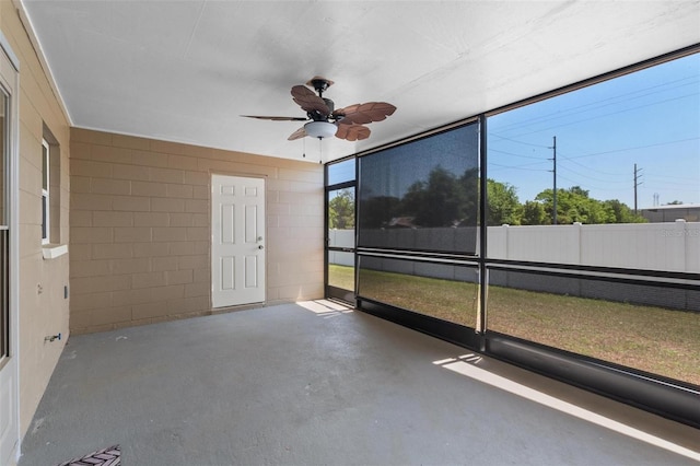 unfurnished sunroom with ceiling fan