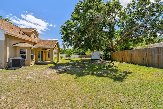 view of yard featuring a fenced backyard and central AC unit