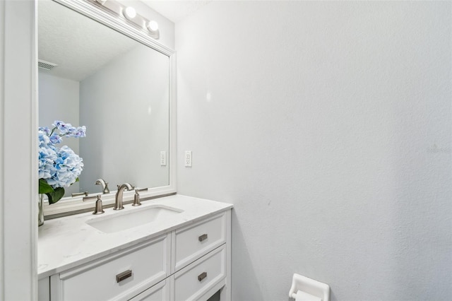 bathroom featuring visible vents and vanity