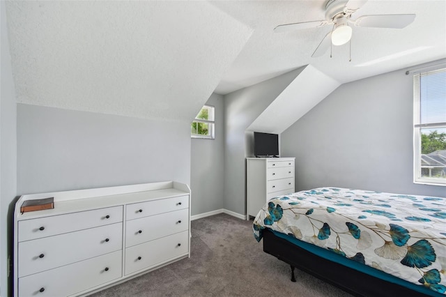 bedroom with baseboards, a textured ceiling, a ceiling fan, carpet floors, and lofted ceiling
