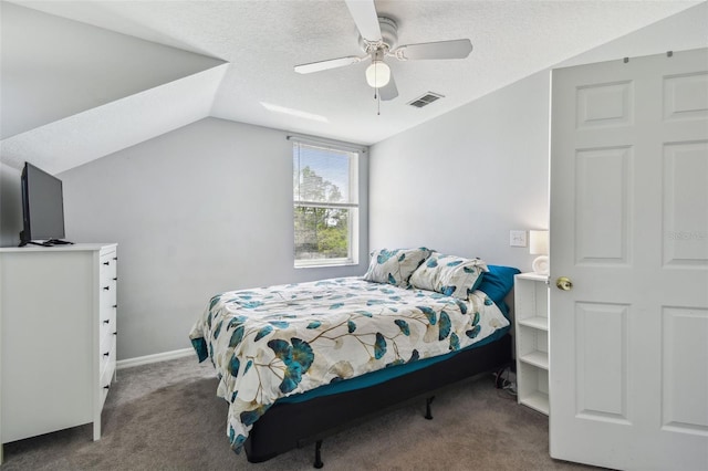 carpeted bedroom with a textured ceiling, a ceiling fan, vaulted ceiling, visible vents, and baseboards