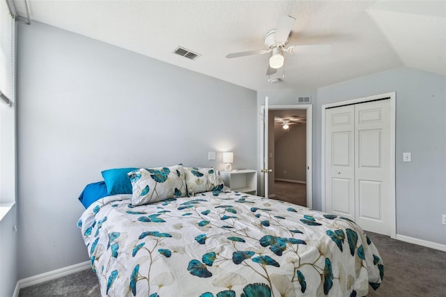 carpeted bedroom with visible vents, ceiling fan, a closet, and vaulted ceiling