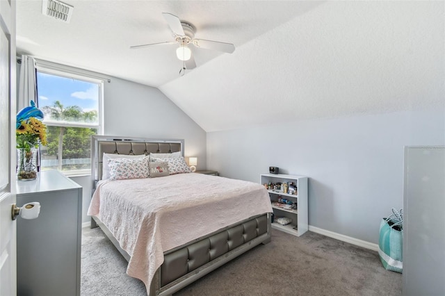 bedroom featuring ceiling fan, vaulted ceiling, visible vents, carpet floors, and baseboards
