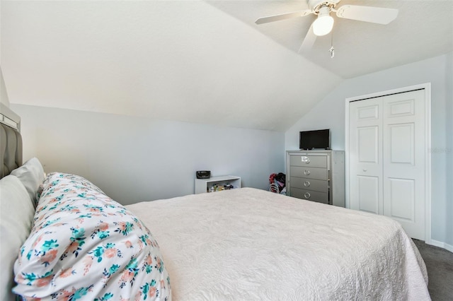 bedroom with baseboards, a closet, a ceiling fan, lofted ceiling, and carpet