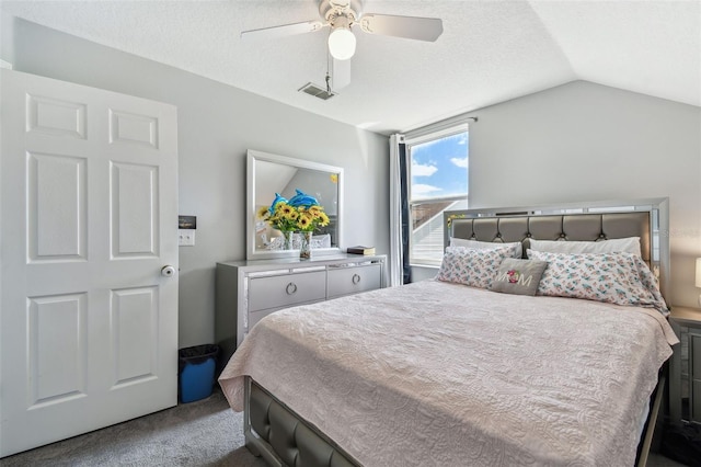bedroom with a textured ceiling, carpet floors, visible vents, lofted ceiling, and ceiling fan
