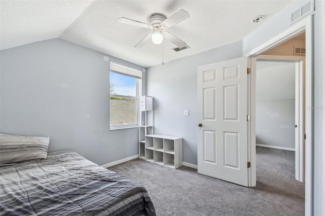 carpeted bedroom with visible vents, baseboards, vaulted ceiling, and a textured ceiling
