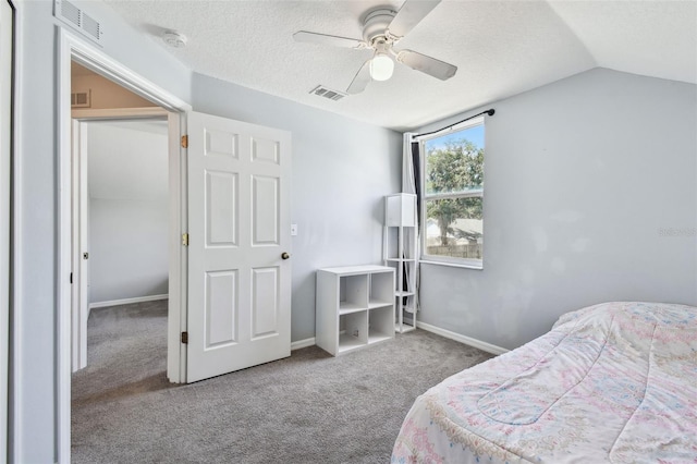 bedroom featuring a textured ceiling, vaulted ceiling, visible vents, carpet flooring, and baseboards
