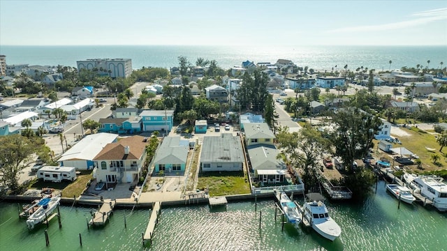 birds eye view of property with a water view and a residential view