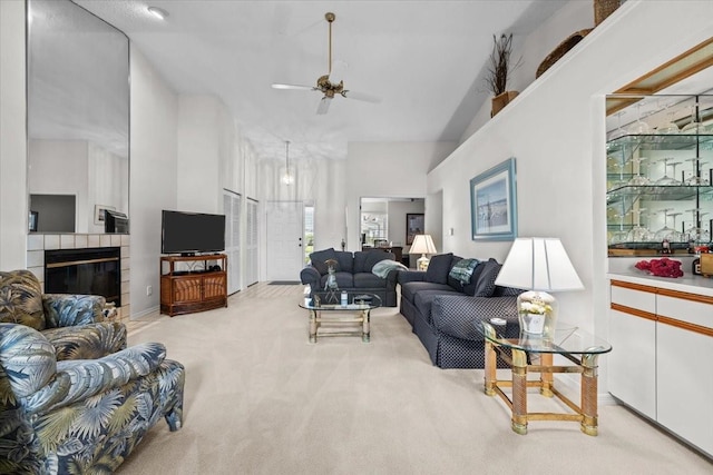 235 Woodridge Cir, Oldsmar, FL 34677 - carpeted living area with a tile fireplace, a high ceiling, and a ceiling fan