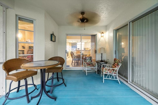 235 Woodridge Cir, Oldsmar, FL 34677 - sunroom / solarium featuring a textured wall, ceiling fan, and carpet