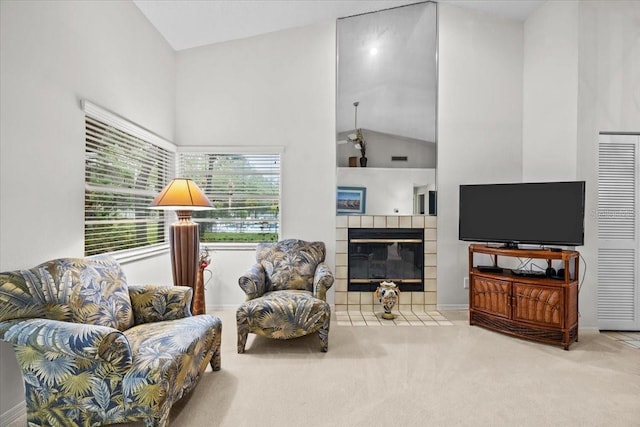 235 Woodridge Cir, Oldsmar, FL 34677 - living room with high vaulted ceiling, a tiled fireplace, baseboards, and carpet floors