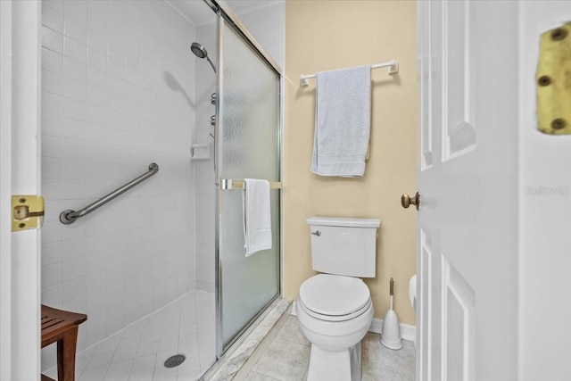 235 Woodridge Cir, Oldsmar, FL 34677 - bathroom featuring a shower stall, tile patterned flooring, baseboards, and toilet