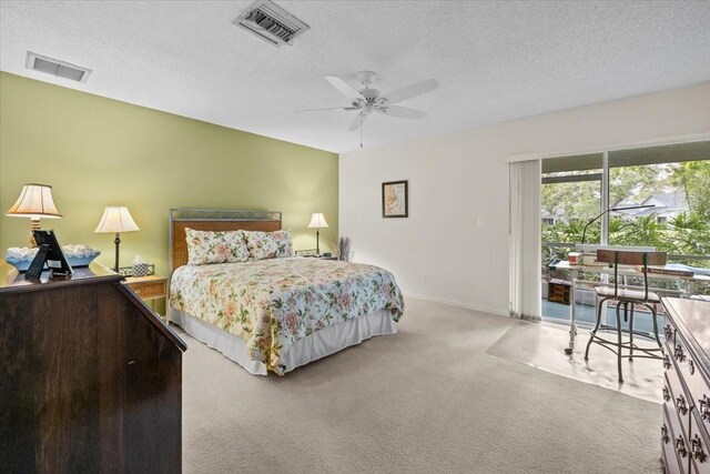 235 Woodridge Cir, Oldsmar, FL 34677 - carpeted bedroom featuring visible vents, access to exterior, and a textured ceiling