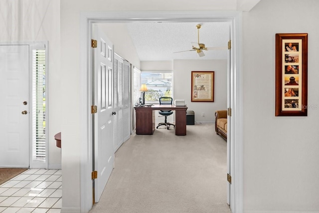 235 Woodridge Cir, Oldsmar, FL 34677 - hallway featuring light carpet, light tile patterned floors, vaulted ceiling, and a textured ceiling