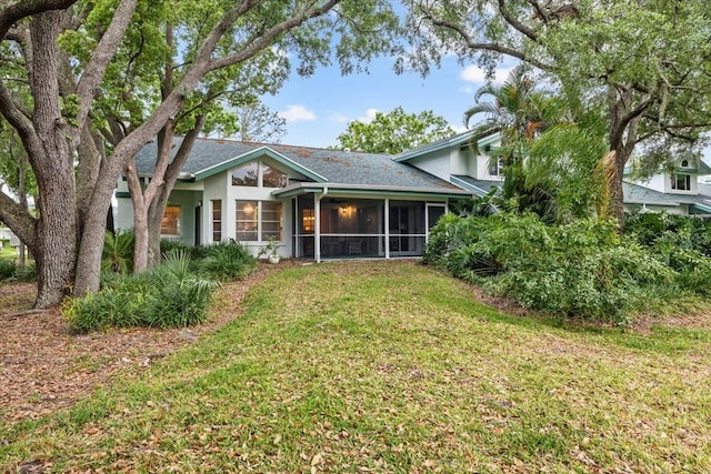 235 Woodridge Cir, Oldsmar, FL 34677 - rear view of property with a sunroom, a yard, and stucco siding