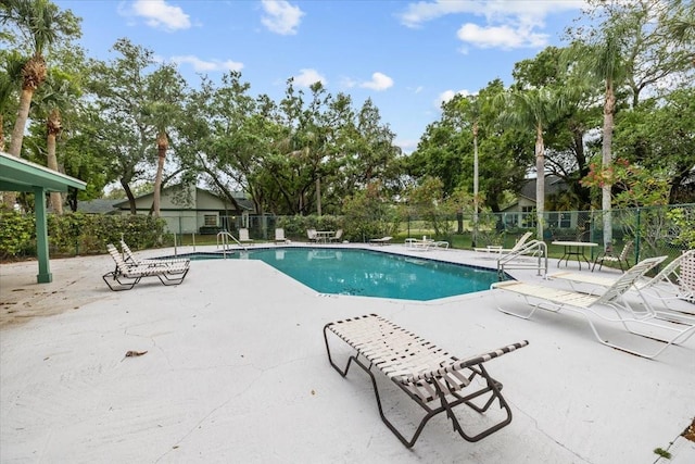 235 Woodridge Cir, Oldsmar, FL 34677 - community pool featuring a patio area and fence