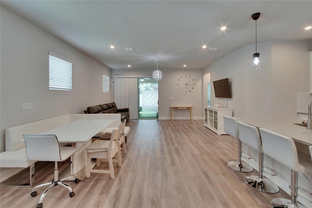 dining space featuring baseboards, light wood-type flooring, plenty of natural light, and recessed lighting