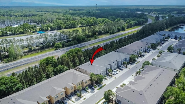 birds eye view of property featuring a view of trees and a residential view