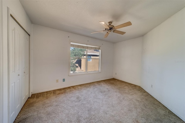 11386 Churchhill Trl, Seminole, FL 33772 - unfurnished bedroom featuring a textured ceiling, a closet, ceiling fan, and carpet floors