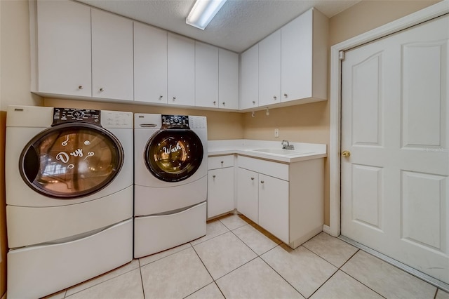 11386 Churchhill Trl, Seminole, FL 33772 - clothes washing area with light tile patterned floors, a textured ceiling, independent washer and dryer, cabinet space, and a sink