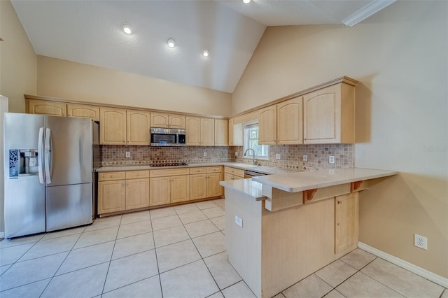 11386 Churchhill Trl, Seminole, FL 33772 - kitchen with light tile patterned floors, a peninsula, light brown cabinets, and stainless steel appliances