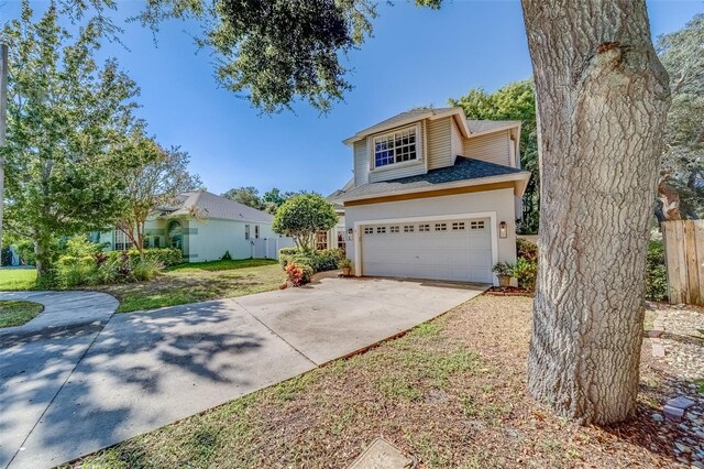 11386 Churchhill Trl, Seminole, FL 33772 - traditional-style home with an attached garage, roof with shingles, concrete driveway, and fence