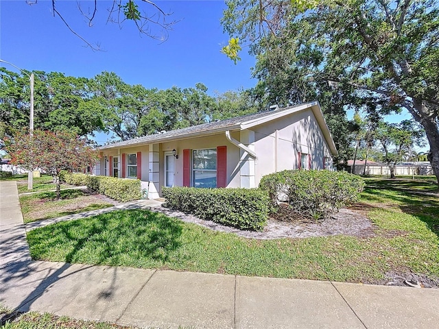 view of front of home featuring a front lawn and stucco siding