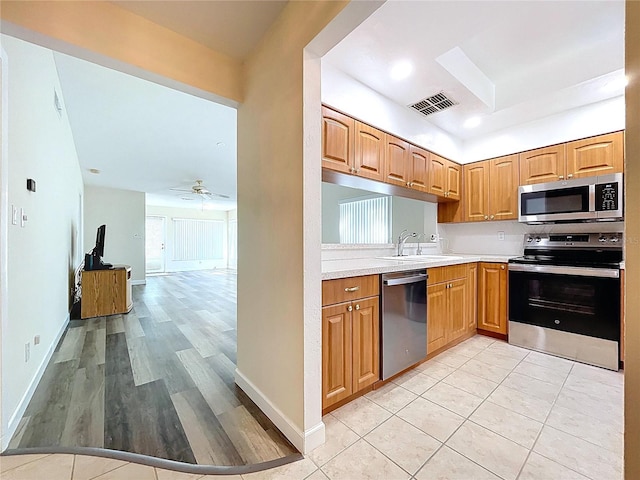 kitchen featuring light countertops, a ceiling fan, visible vents, stainless steel appliances, and a sink