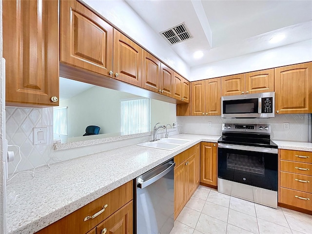 kitchen featuring visible vents, backsplash, appliances with stainless steel finishes, and light tile patterned floors