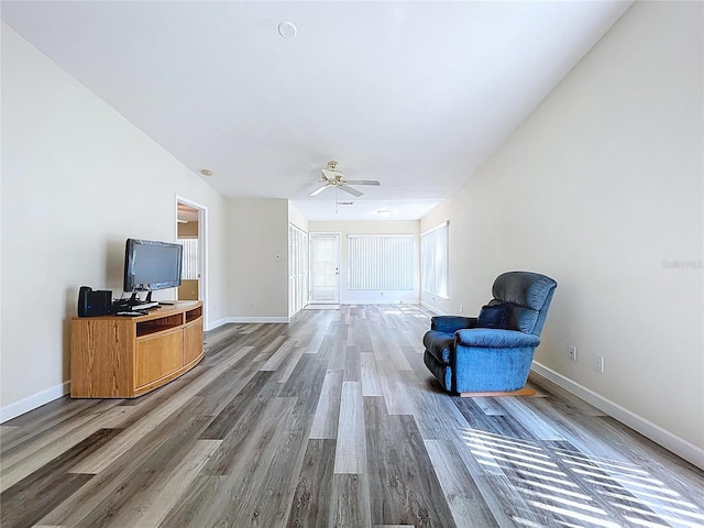 unfurnished room featuring wood finished floors, ceiling fan, and baseboards