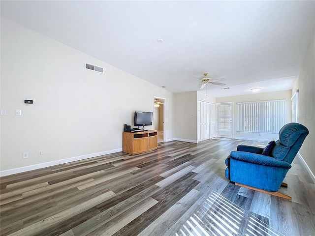 living room featuring visible vents, ceiling fan, baseboards, and wood finished floors