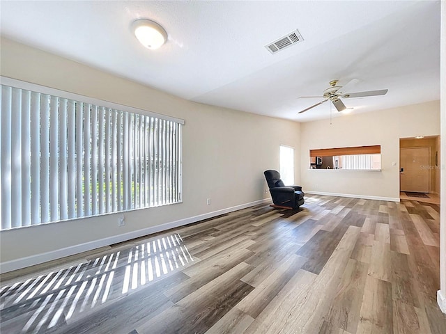 unfurnished room with visible vents, baseboards, a ceiling fan, and wood finished floors