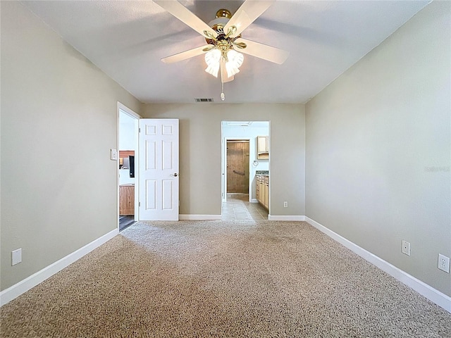 unfurnished bedroom with connected bathroom, light colored carpet, a ceiling fan, visible vents, and baseboards
