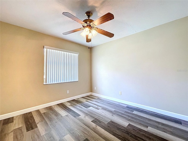 unfurnished room with baseboards, a ceiling fan, and wood finished floors